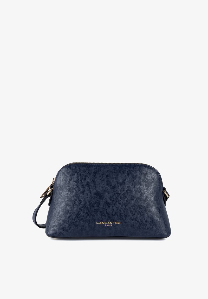 Borsa a tracolla in pelle blu navy con texture a grana, forma arrotondata, dettagli in metallo dorato e chiusura con zip. Presenta il logo del marchio sul davanti.