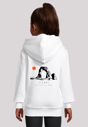 White hoodie featuring a graphic of a rock formation and a sun in orange. Text beneath the design reads "ESCAPE AND DISCOVER THE WORLD."