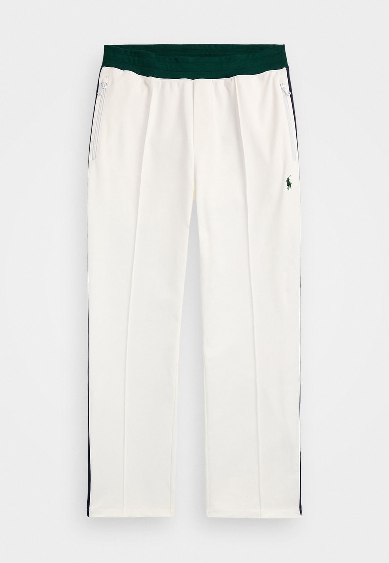 Pantalon de sport blanc avec une taille élastique verte, des poches latérales et des rayures d'accent bleu marine le long des côtés ; présente un petit logo vert.