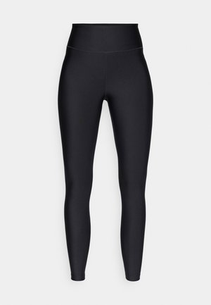 Leggings negros de talle alto hechos de tela elástica y suave; diseño ajustado sin costuras visibles ni adornos, que ofrece una apariencia elegante.