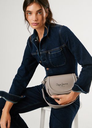 Pilkas dirbtinės odos rankinis krepšys su išlenktu dizainu, įspaustas "Pepe Jeans" logotipas ir nuimamas diržas. Nešiojamas ant džinsų aprangos.