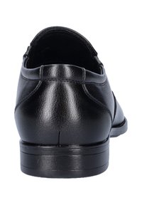 Black leather shoe with a smooth texture, rounded toe, and minimal stitching. Low heel and flat outsole for comfort. Rear view shown.