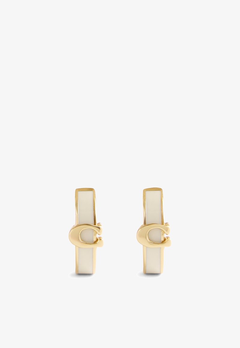 Złote kolczyki w kształcie kół, z błyszczącym białym paskiem i zapięciem, o gładkiej powierzchni i minimalistycznych akcentach.