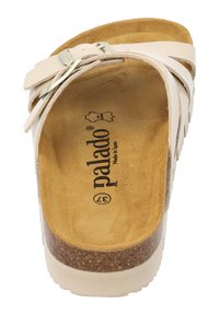 Sandal in beige chiaro con suola in sughero, chiusura regolabile e rivestimento interno testurizzato. Marchio visibile sulla suola.