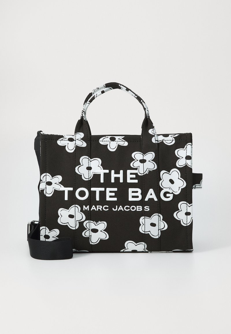 Geantă tote neagră Marc Jacobs cu modele de flori albe, mânere duale și curea de umăr detasabilă, având inscripția "THE TOTE BAG".