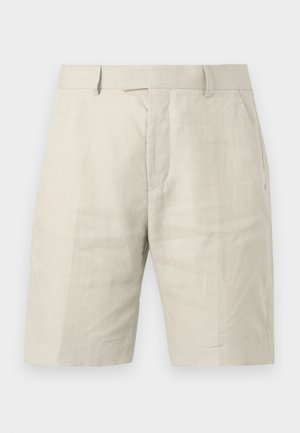 Világos bézs színű, térdig érő rövidnadrág, övbújtatókkal, elülső zsebekkel és rejtett elülső záródással.