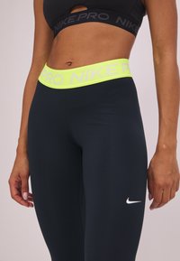 Nike Performance Tights - black/yellow