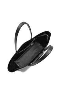 Black leather tote bag with two handles, open top, and textured interior pocket. Features a smooth finish and minimalist design.