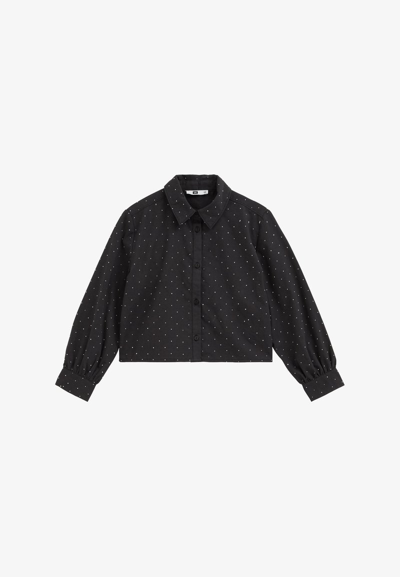 Chemise courte noire à manches longues avec petits pois blancs, boutons sur le devant et col.