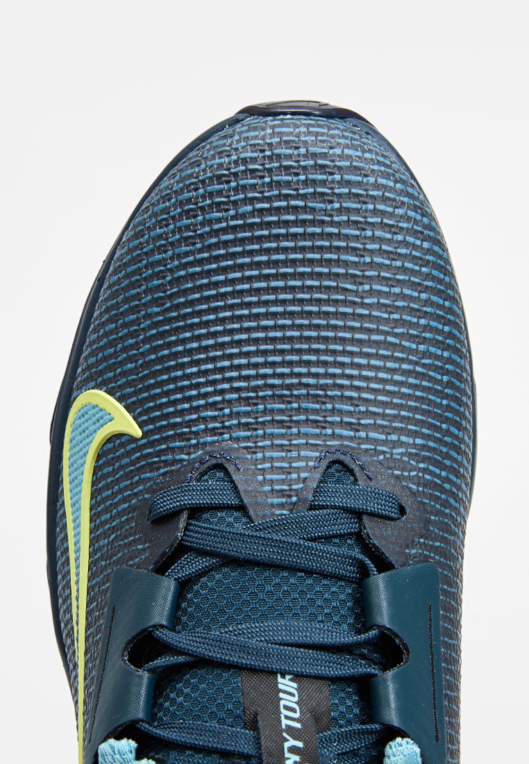 Blauwe sportschoen met een gestructureerde synthetische bovenkant, gele accenten en een traditioneel vetersysteem. Lichtgewicht ontwerp voor comfort.