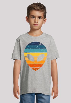 Gray cotton t-shirt featuring a large retro alien head graphic with horizontal blue, teal, orange, and yellow stripes, worn by a child.