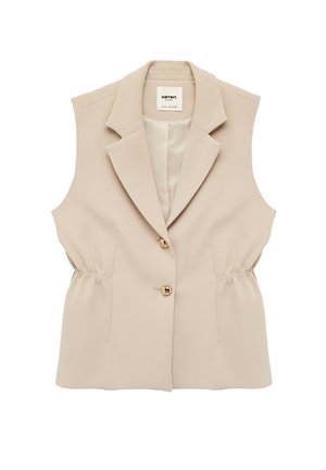 Ærmeløs beige blazer-vest med reverskrave, to gyldne knapper og rynkede elastiske sider på hvid baggrund.