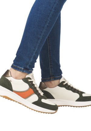 White sneakers with green and orange accents, textured suede and smooth leather, featuring a rubber sole with a zigzag pattern.