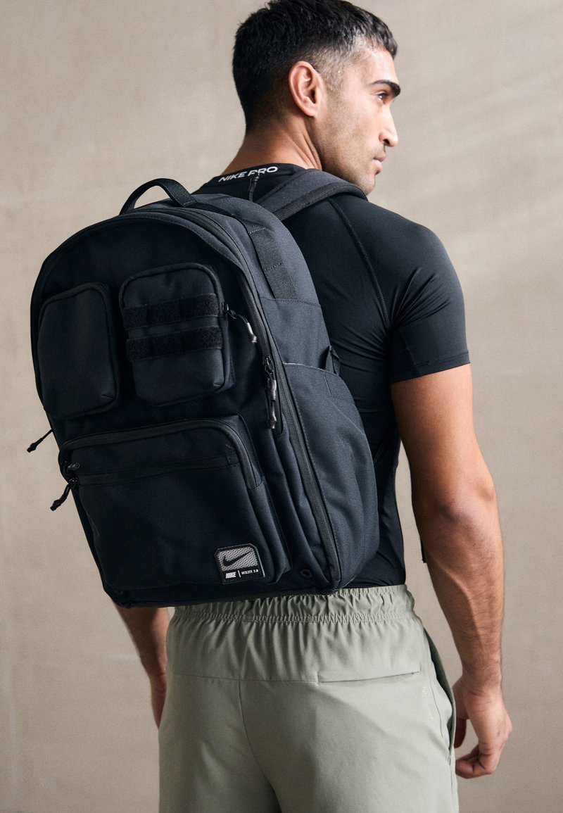 nike backpack utility power USATF Team USATF Store Made from Sustainable MaterialsThis product is made with around 65% recycled polyester materials Product FeaturesDensely woven polyester material Spacious main compartment Internal 16 laptop sleeve Zippered front compartments Side water bottle pockets Padded back and shoulder straps Chest strap Top haul handle Luggage passthrough Gusset vent 14 W x 19 H x 6 D 33L capacity 100% polyester Spot clean The Nike Utility Power Backpack (33L) is imported Nike Performance UTILITY POWER UNISEX