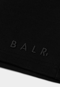 Black cotton fabric with textured surface. Features embroidered "BALR." logo in matching black thread, positioned at the bottom edge.