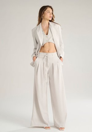 Light gray cropped blazer and matching wide-leg trousers. Textured fabric with front pleats and drawstring waist. Simple button detail on top.