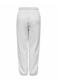Lysegrå sweatpants lavet af blødt stof, med elastisk talje og manchetter, afslappet pasform og uden synlige lommer.