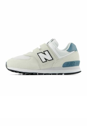 Hvid og lyseblå New Balance-sneaker med velcrolukninger, mesh- og ruskinds-ovdel, og sort gummisål set fra siden.