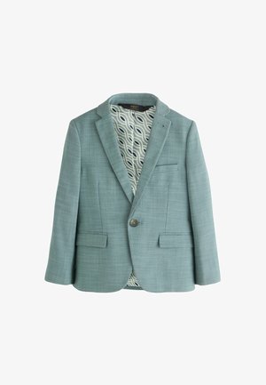 Helehelesinine bleiser, mis on valmistatud tekstuuriga kangast, kahe esise pisipocketiga ja ühe nupuga sulgemisega. Vooder on lainelise mustriga kangast.