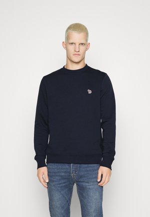 Navy sweatshirt with round neckline, ribbed cuffs, and hem. Features a small colorful embroidered logo on the chest. Soft fabric texture.