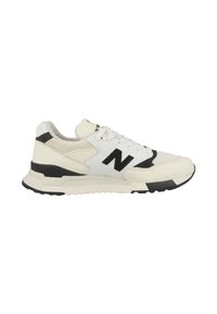 White and black athletic sneakers with a mesh upper and leather accents. Features a prominent black 'N' logo and textured sole for grip.