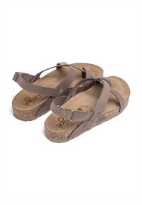 Sandalias de cuero marrón con plantilla de corcho, que cuentan con tiras entrelazadas y cierre ajustable en el tobillo. Suela texturizada para mayor agarre.