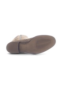 Bottombesole met een gladde, bruine rubberen afwerking. Voorzien van een geprofileerd grippatroon en een gebogen rand voor een ergonomische pasvorm. Ritsdetails zichtbaar aan de zijkant.