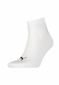 White ankle sock made of a smooth, stretchy material. Features a black logo on the toe area and a ribbed cuff for fit.