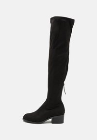 Black over-the-knee boot made of soft suede fabric, with a block heel and side zipper detail for easy wear. Smooth texture.