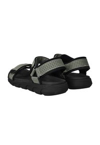 Black and gray sandals with thick rubber soles. Features adjustable straps with a grid pattern and padded areas for comfort.