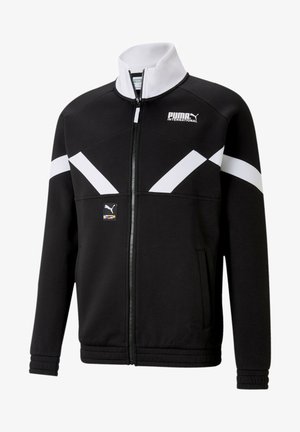 Mustatakki, jossa on valkoisia diagonaalisia yksityiskohtia, korkea kaulus, etuvetoketju ja sivutaskut. Vasemmassa rinnassa on pieni logo-patch.