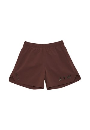 Man wearing maroon long-sleeve shirt, matching shorts with black "ATW" text, white socks, and gray running shoes, standing against gray background.