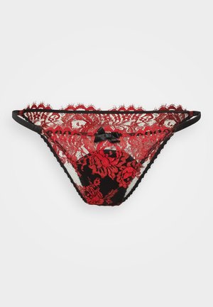 Black lace thong with red floral pattern, featuring scalloped edges and a small black bow accent at the center, sheer fabric texture.