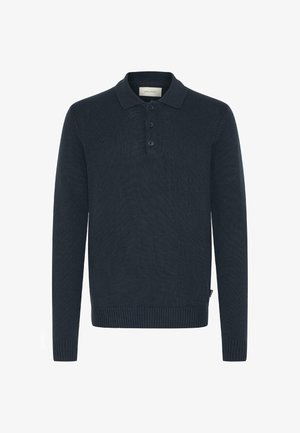 Donkerblauwe langemouwen polo, geribbelde textuur, met een drie-knopen sluiting en aansluitende manchetten. Het materiaal lijkt zacht en iets rekbaar.