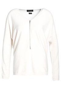 Vit stickad tröja med V-ringning och dragkedja fram. Har långa ärmar och en avslappnad passform. Slät textur med en subtil glans.