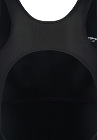 Bodysuit de sport noir avec un col rond et un dos ouvert. Fabriqué en tissu lisse et extensible, avec des coutures renforcées et un détail de logo discret.