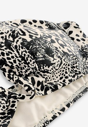 Sutien de bikini cu imprimeu de leopard, realizat dintr-un material negru și crem, cu curele laterale. Textură netedă, cu modele contrastante și un finisaj moale.
