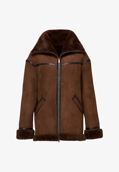 Pruun seemisjakk suure lambanahast kraega, lukuga ees, mustadest nahast detailide ja kahe diagonaalse avaga eesttaskuga.