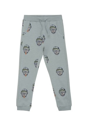 Ljusgrå joggerbyxor gjorda av mjukt material, med ett tryck av monkyansikten som bär mössor över hela ytan, ribbade muddar och resår i midjan.