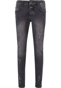 Kitsene slim-fit mustad teksad kerge kulumist ja värvipritsmete detailidega. Viie-tasku disain, nupuga sulgemine ja vöörihmade augud.