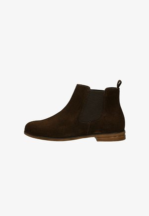 Bottines Chelsea en suédine marron foncé avec panneau latéral en élastique, petit talon en bois et tirette à l'arrière.