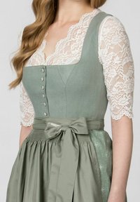 Green linen dirndl with lace sleeves, featuring a fitted bodice, button details, a matching sash, and a pleated skirt with floral accents.