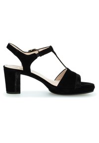 Sandale femme en daim noir avec orteils ouverts, bride de cheville avec boucle et talon bloc sur fond blanc.