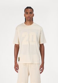 New Era Marškinėliai su spaudiniu - beige