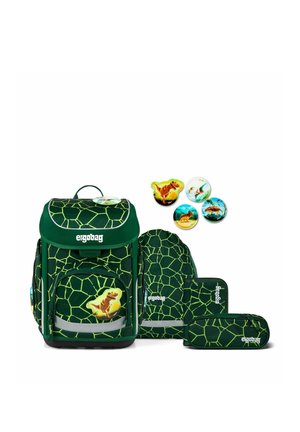 Dark green school bag set with light green geometric pattern, dinosaur pins, and matching pencil cases arranged on white background.