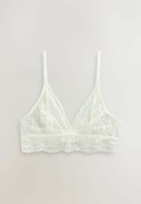Bela čipkasta braletka z nastavljivimi tankimi naramnicami, cvetličnim čipkastim vzorcem in valovito obrobo vzdolž spodnjega traka.