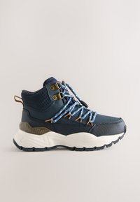 Marineblå højtop-sneaker med tekstureret stof, kontrasterende lyseblå snørebånd, guldøjelets og en chunky hvid og grå sål.