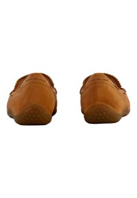 Zapatos de ante marrón tipo slip-on con punta redondeada, detalles de costura sutiles y suelas de goma texturizadas que presentan pequeños patrones de agarre redondeados.