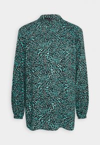 Lätt långärmad skjorta med ett design av turkos och svart leopardmönster. Mjuk tyg med krage och avslappnad passform.