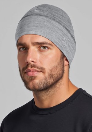 Gray beanie with a smooth texture, featuring stitched detailing and a logo accent. Worn snugly, covers the head completely.